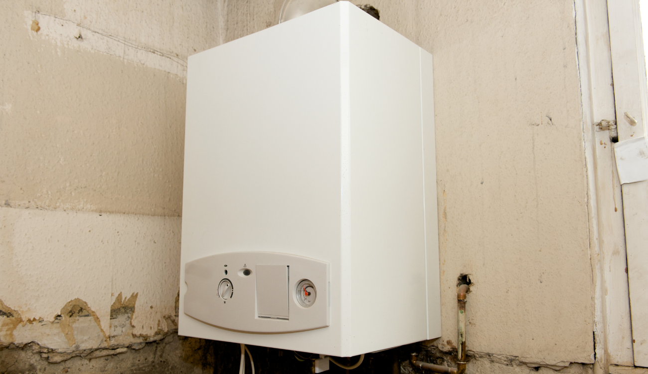 An old boiler mounted on a wall in a house