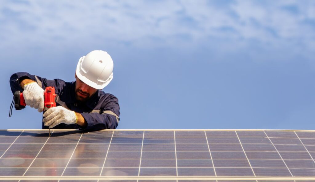 An engineer installing solar panels on a roof
