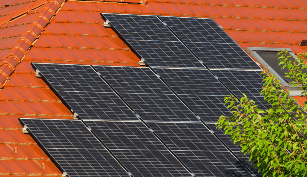 black solar panels installed tiled roof